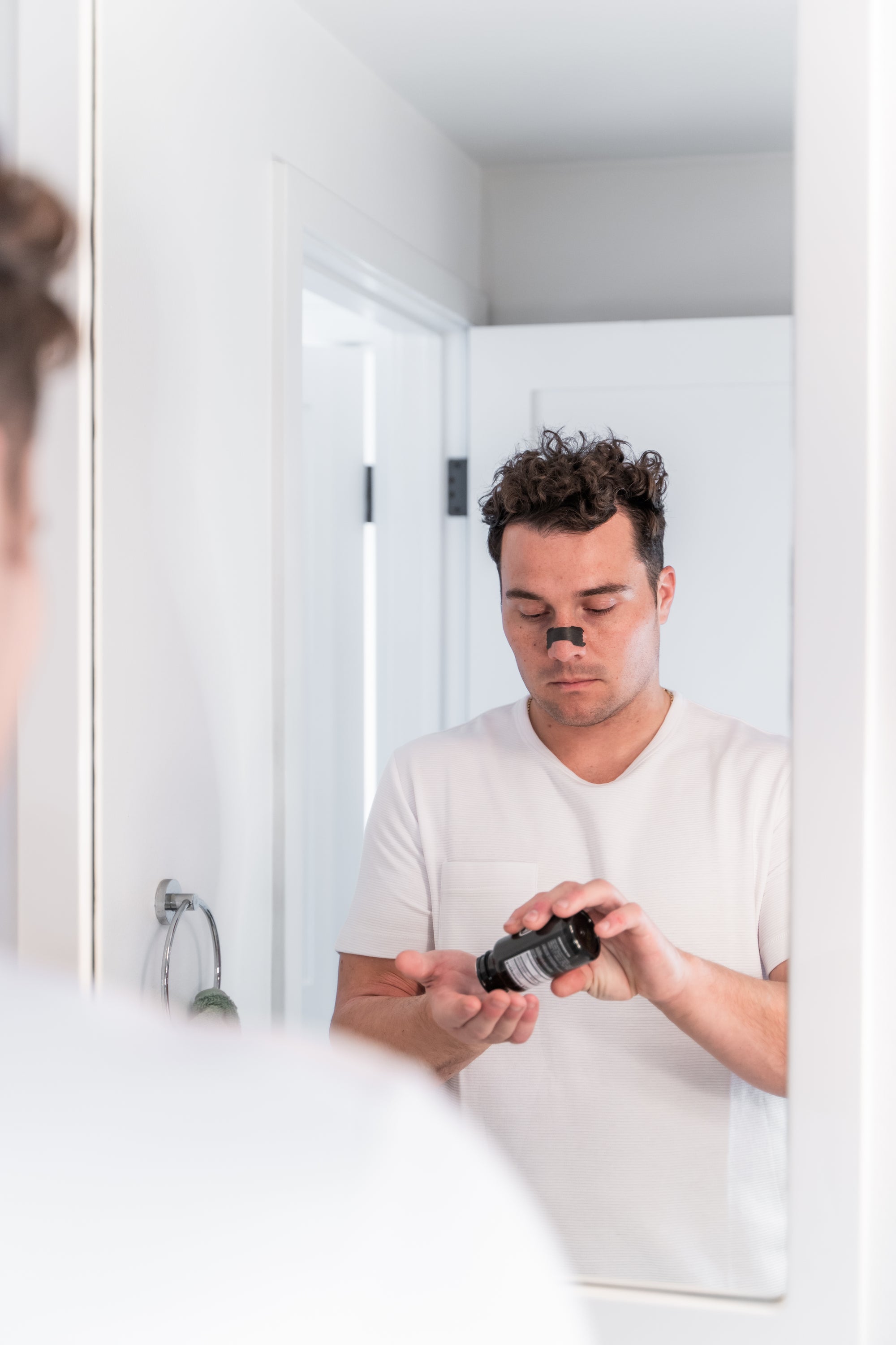 Man using Knocked Nose Strips and taking Knocked Sleep Support Supplement