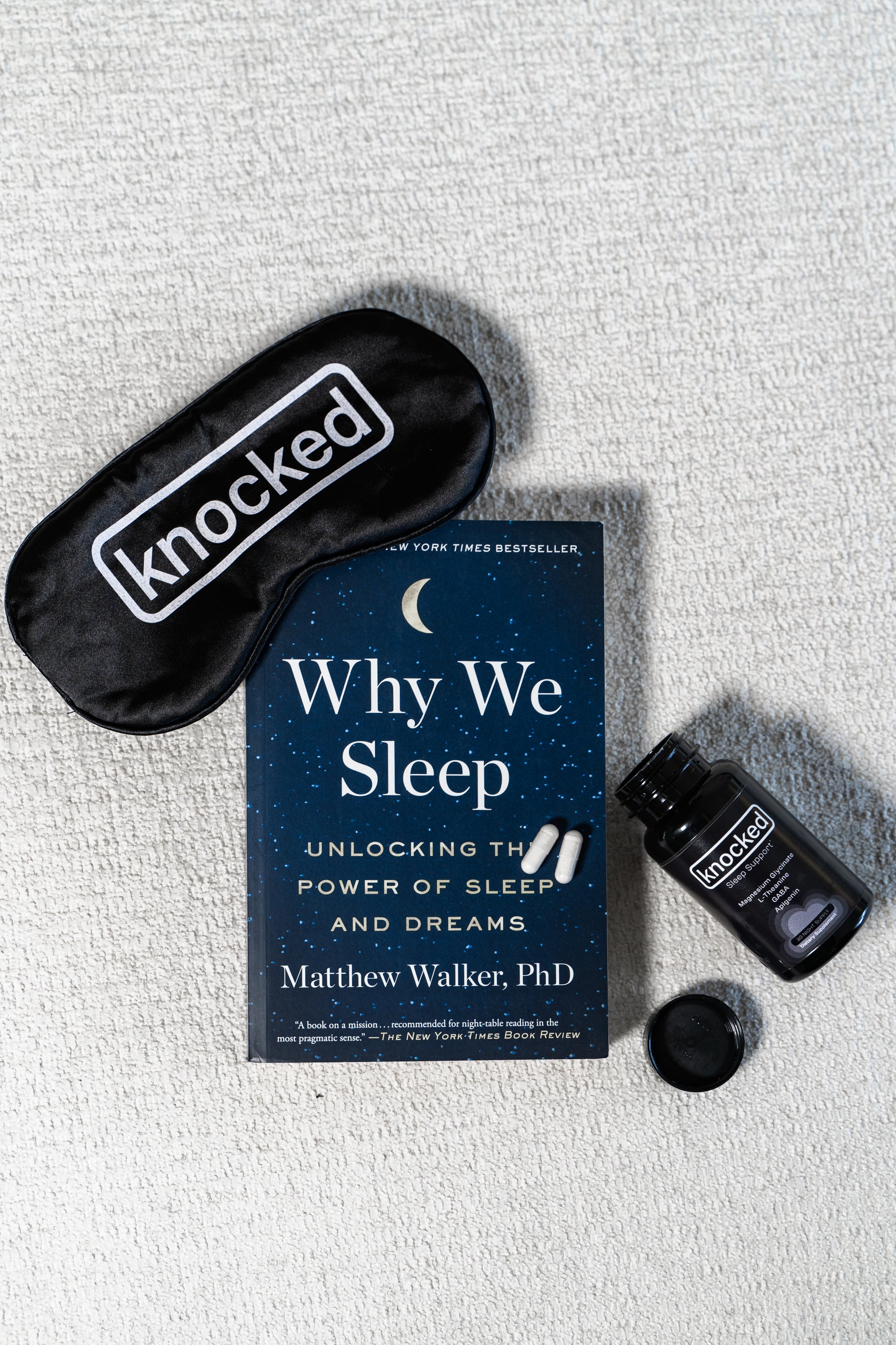 Why We Sleep by Dr. Matthew Walker next to Knocked Sleep Supplement and Knocked Eye Mask